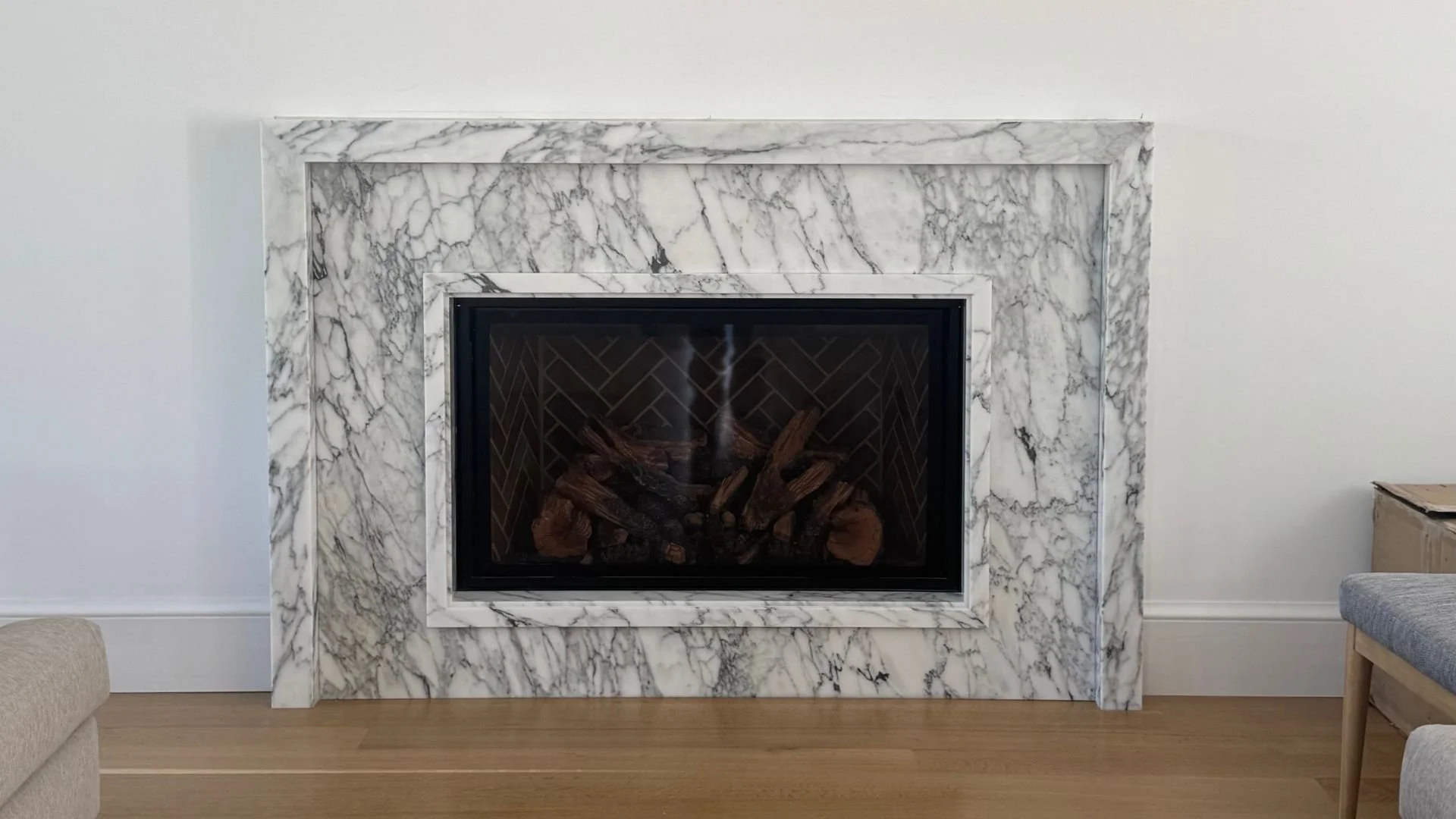 Carrara mitered marble modern fireplace surround by Intermarble in Long Island, New York