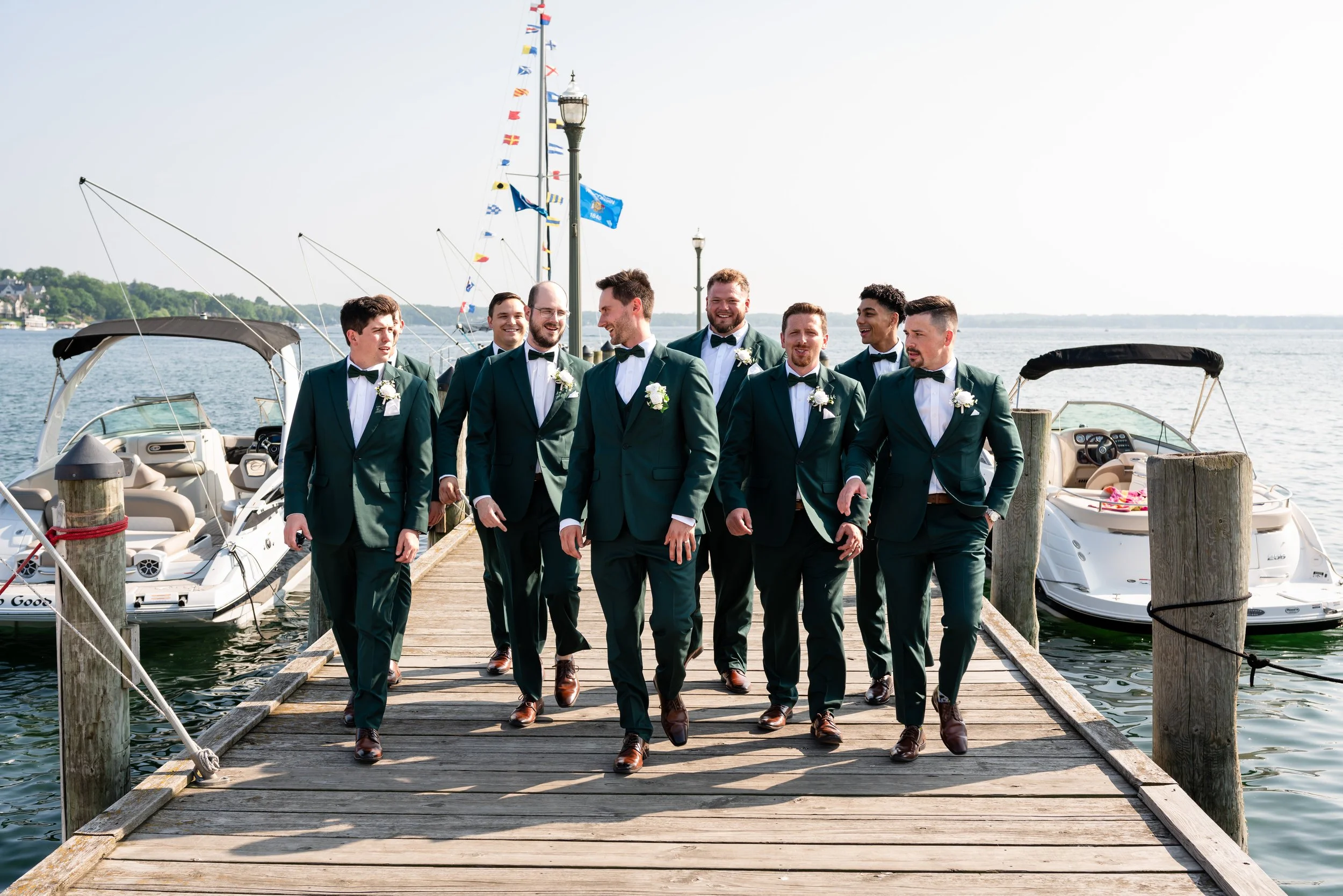 Groomsmen walking down a dock