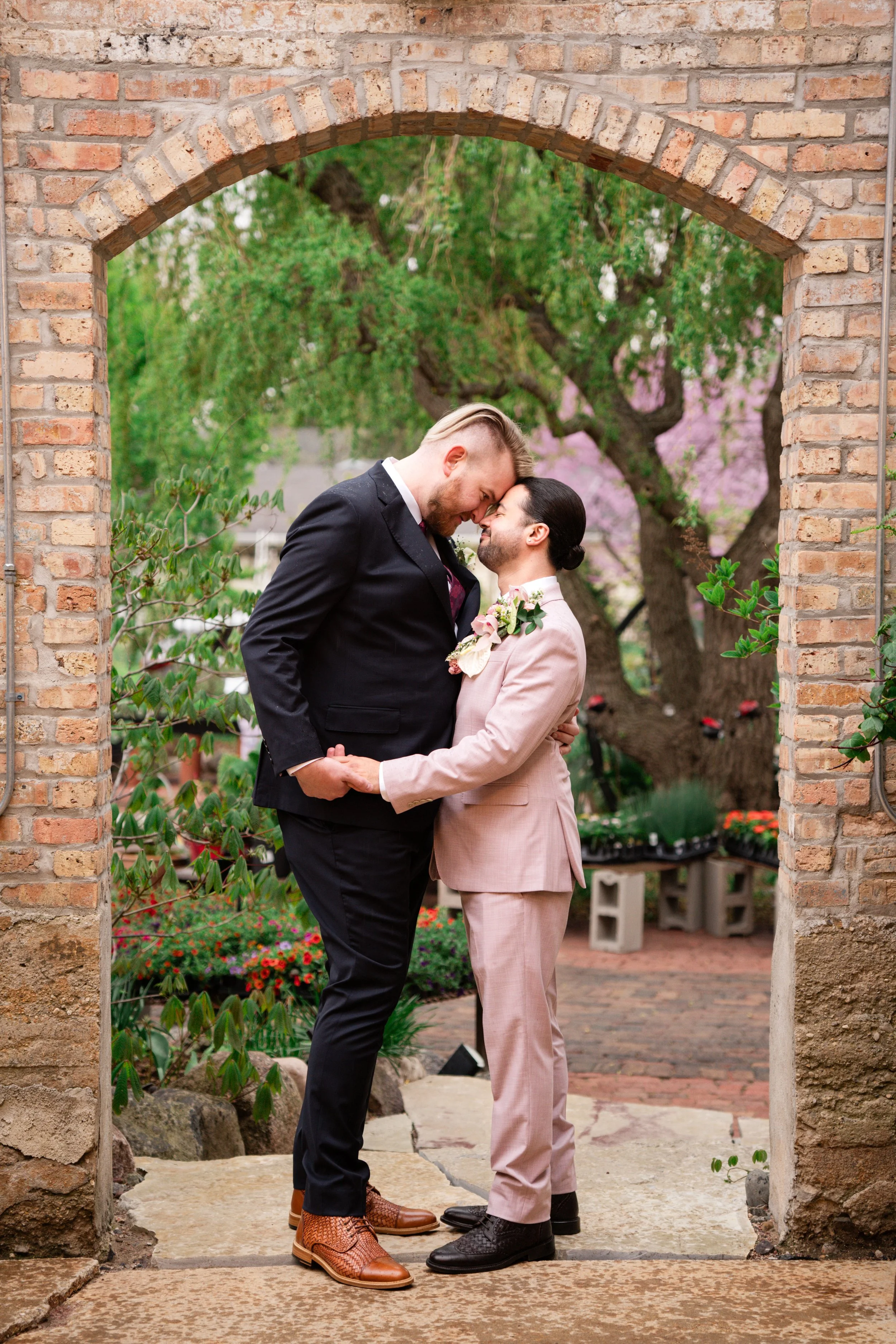 Two grooms in an archway