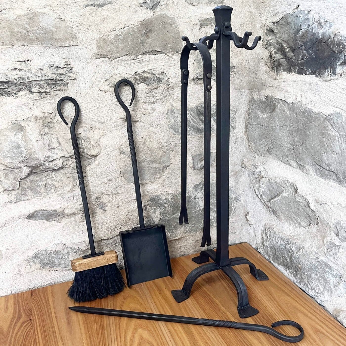 Forged blacksmith fireplace tool set with brush, pan, tongs, and poker