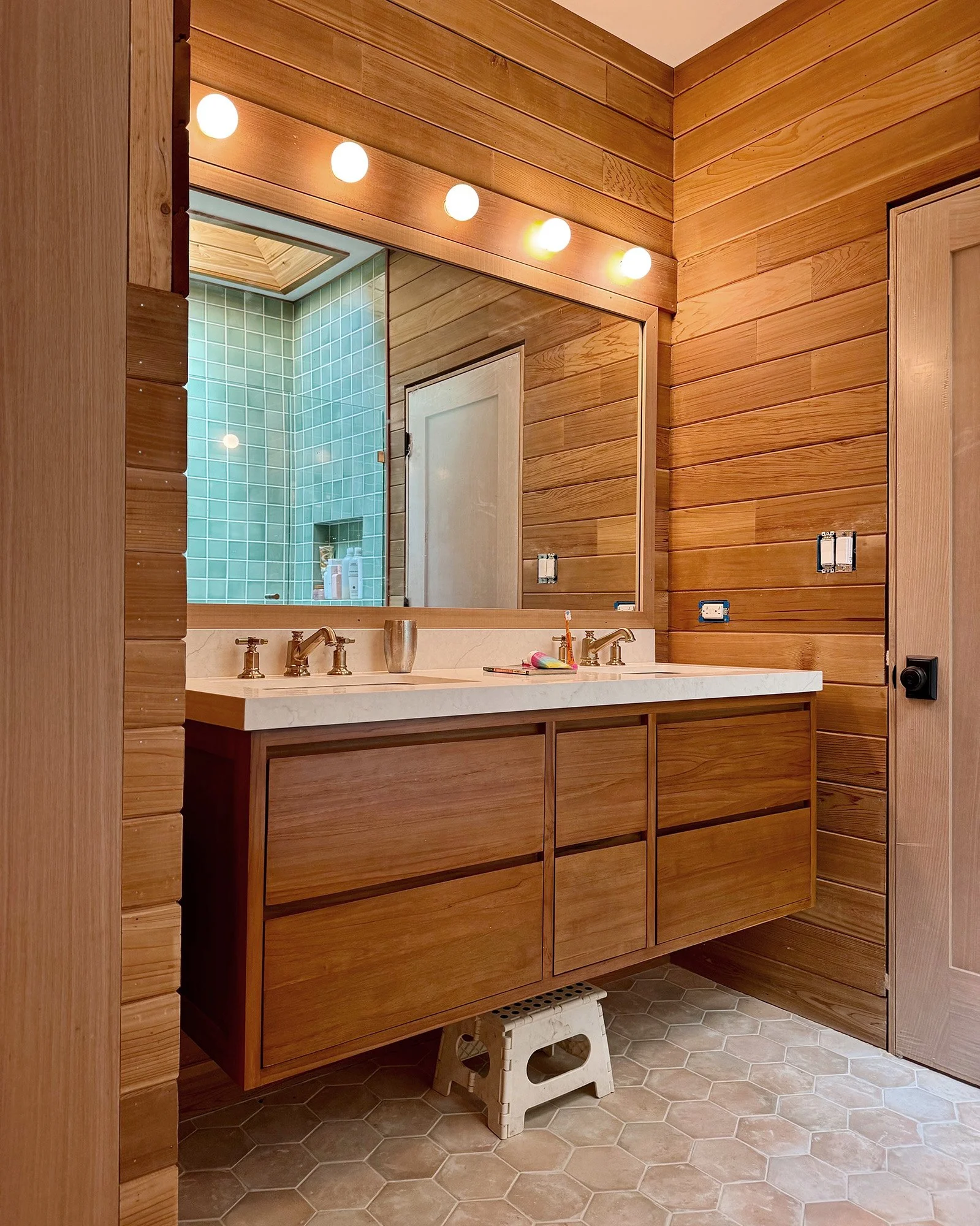 Bathroom with redwood vanity and warm wood walls in Mill Valley