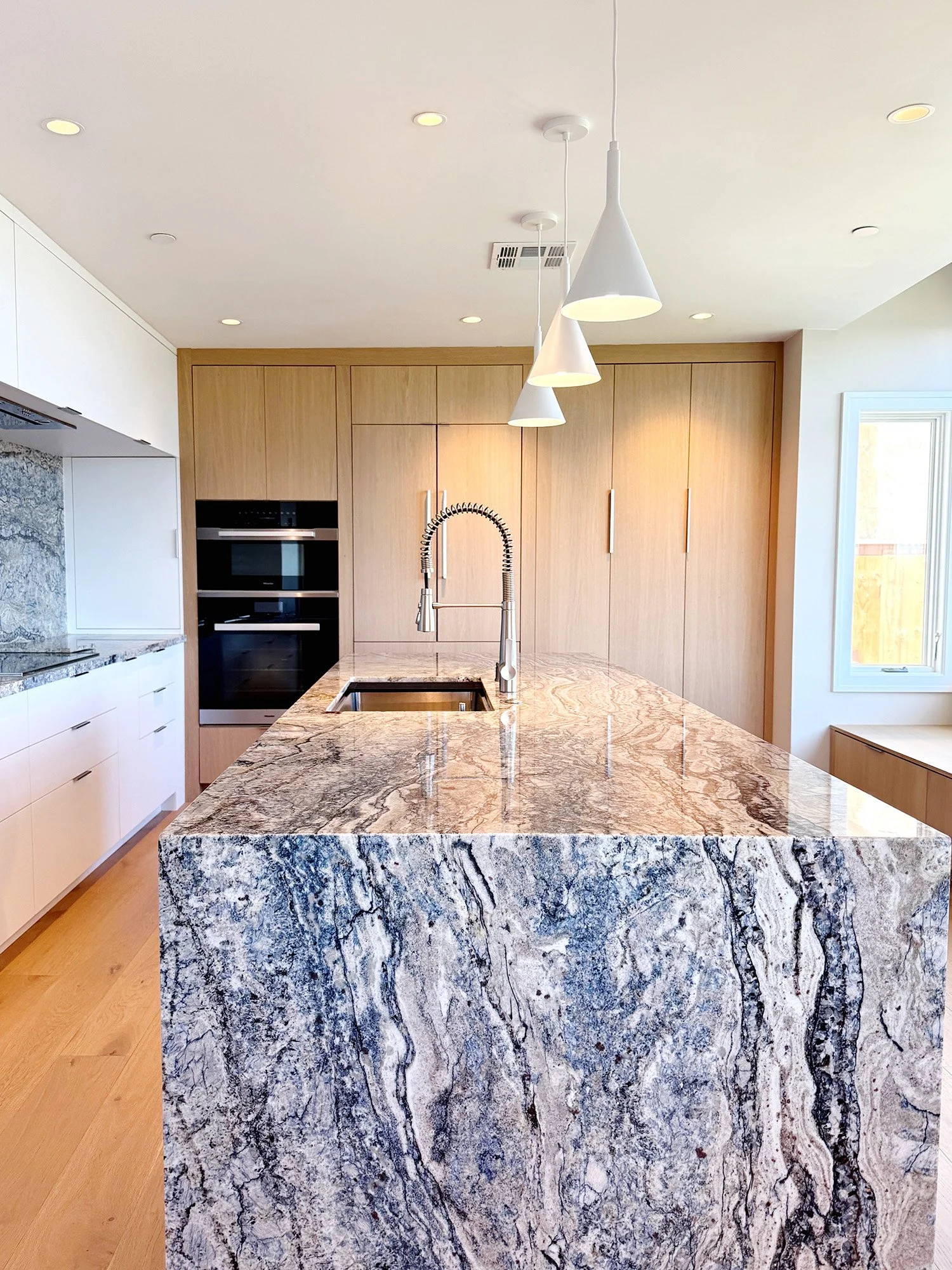 Quartzite kitchen island with sink in San Carlos home