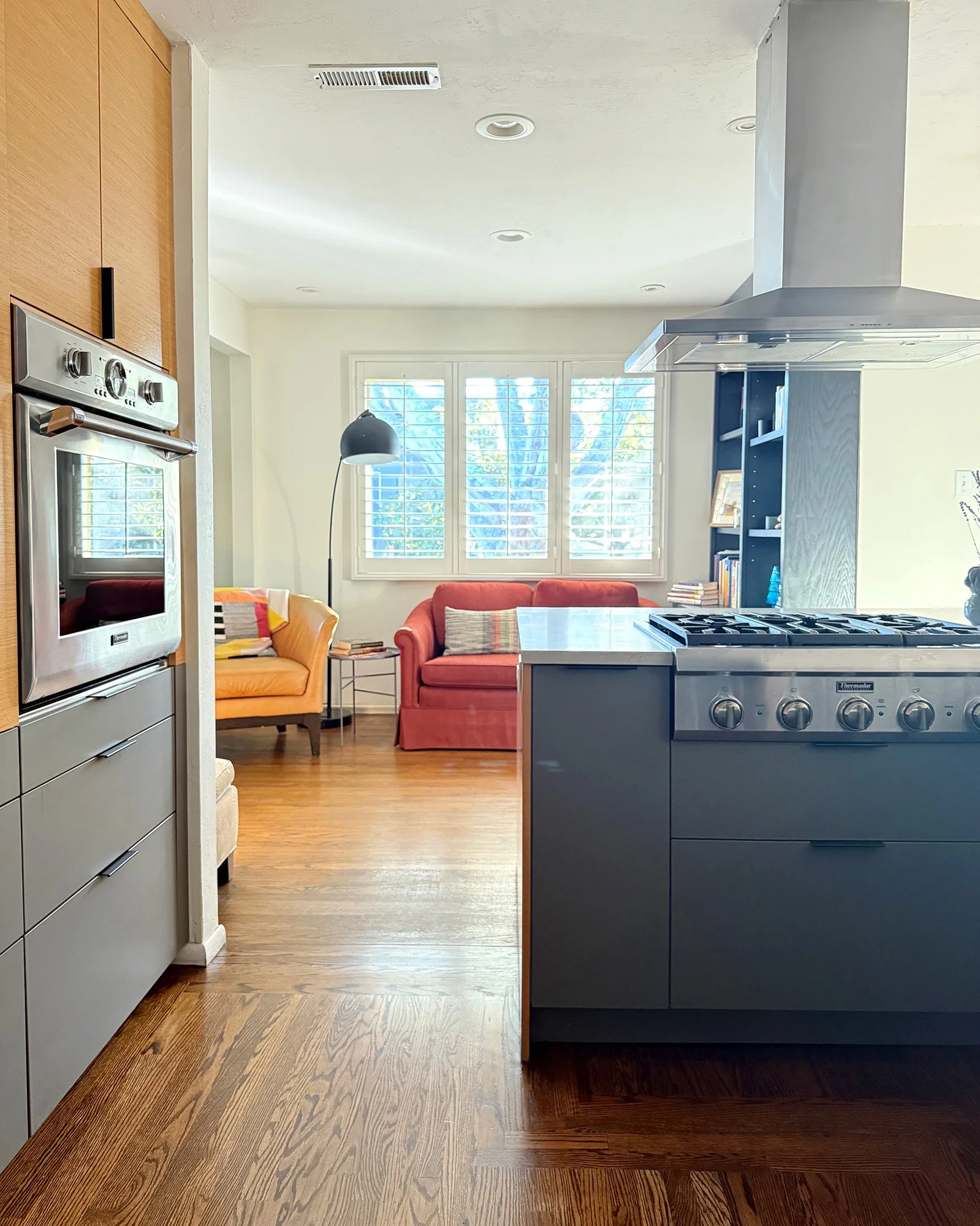 Kitchen with range and view into adjacent living space