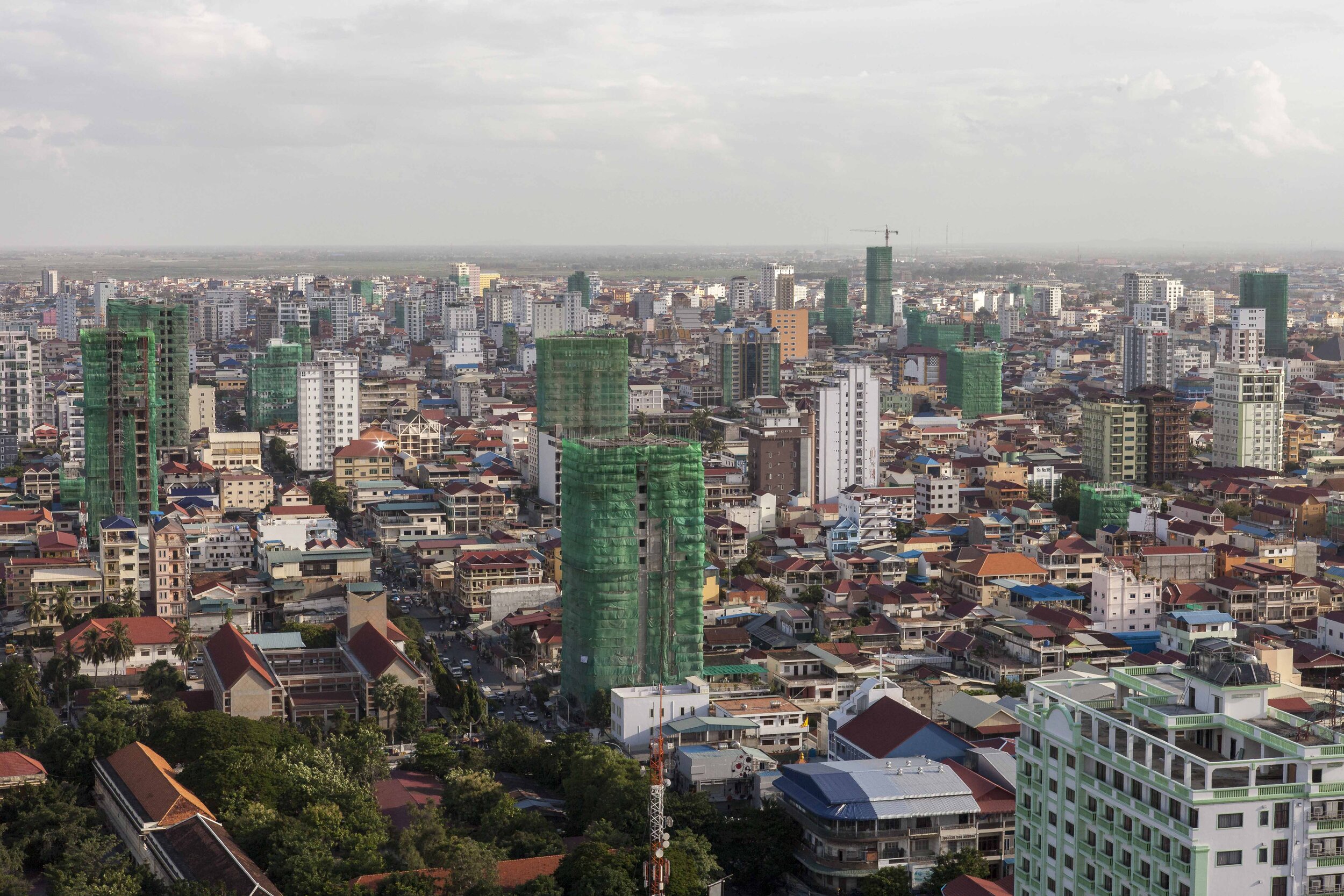 A view south from central Phnom Penh, across a skyline dominated by the shrouds of high-rise construction. 