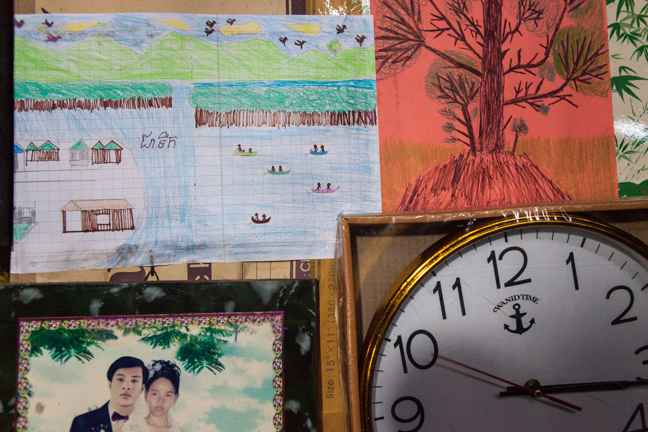  A child’s artwork inside a home in Koh Sralau depicts the island, mangrove forests, and locals fishing.  