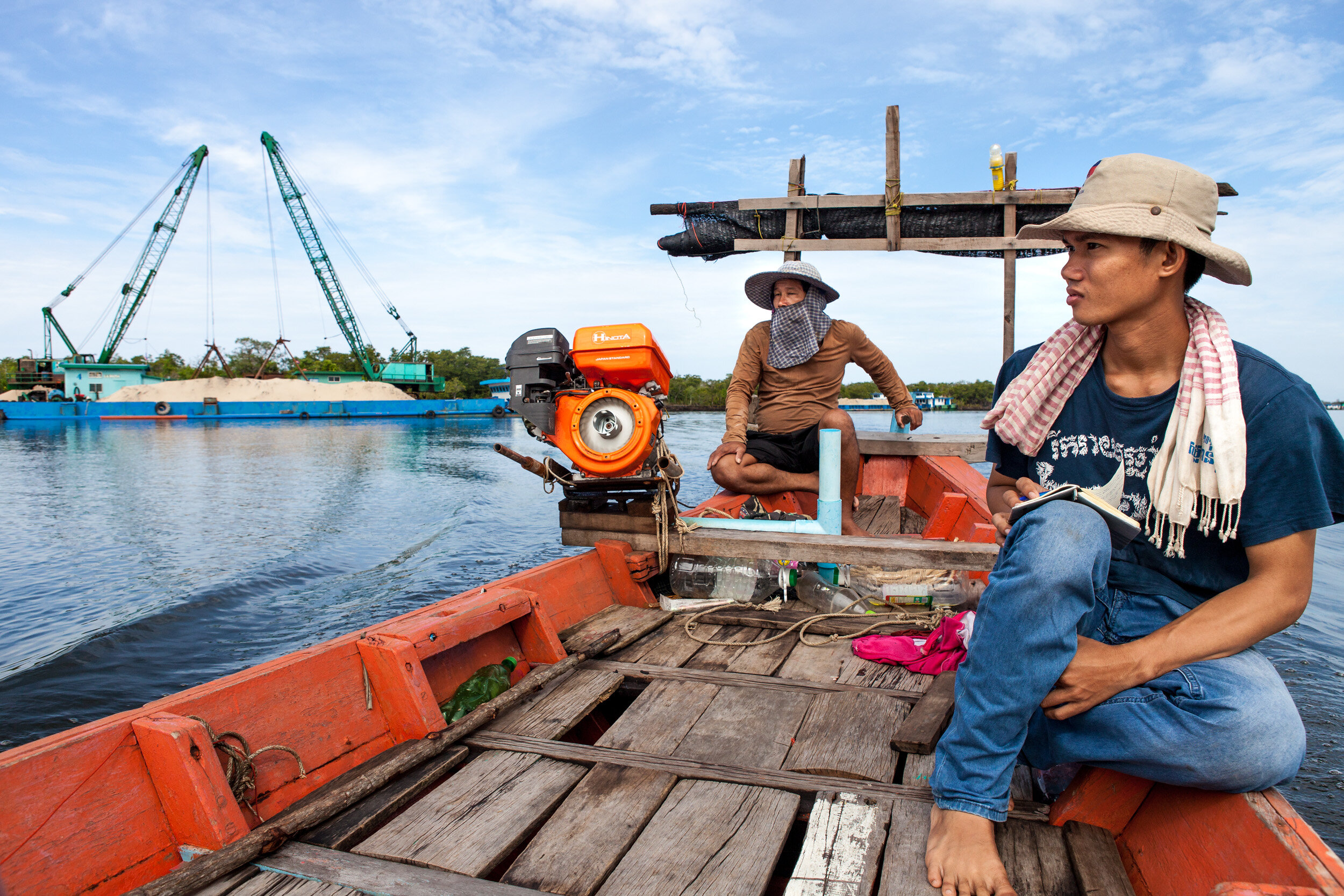  Phen Sophany and Mot Kimry- both ‘Mother Nature’ activists- travel past moored sand dredgers as they inspect the condition of the Tatai River in Koh Kong province. 