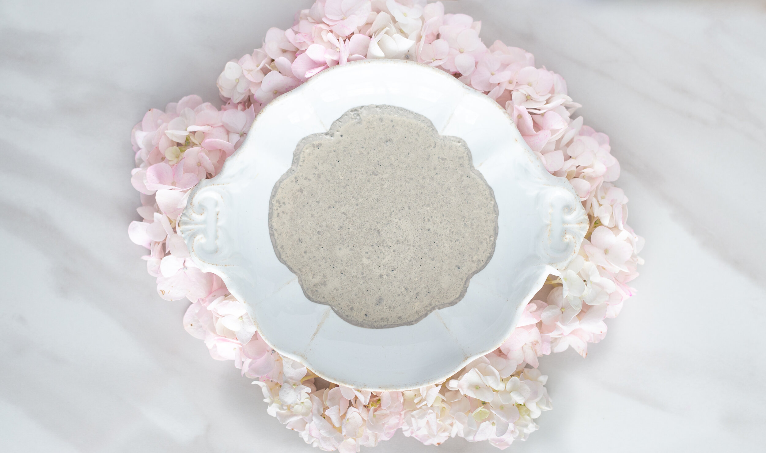 Schloss by Miss Mustard Seed’s® Milk Paint in ironstone bowl surrounded with hydrangeas