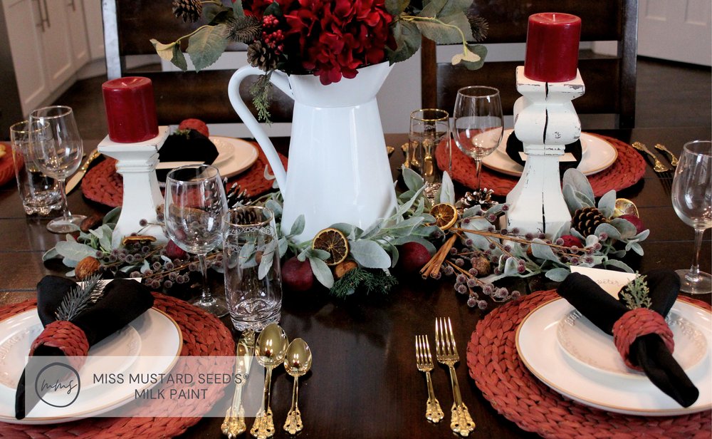White enamel pitcher in a Christmas centerpiece
