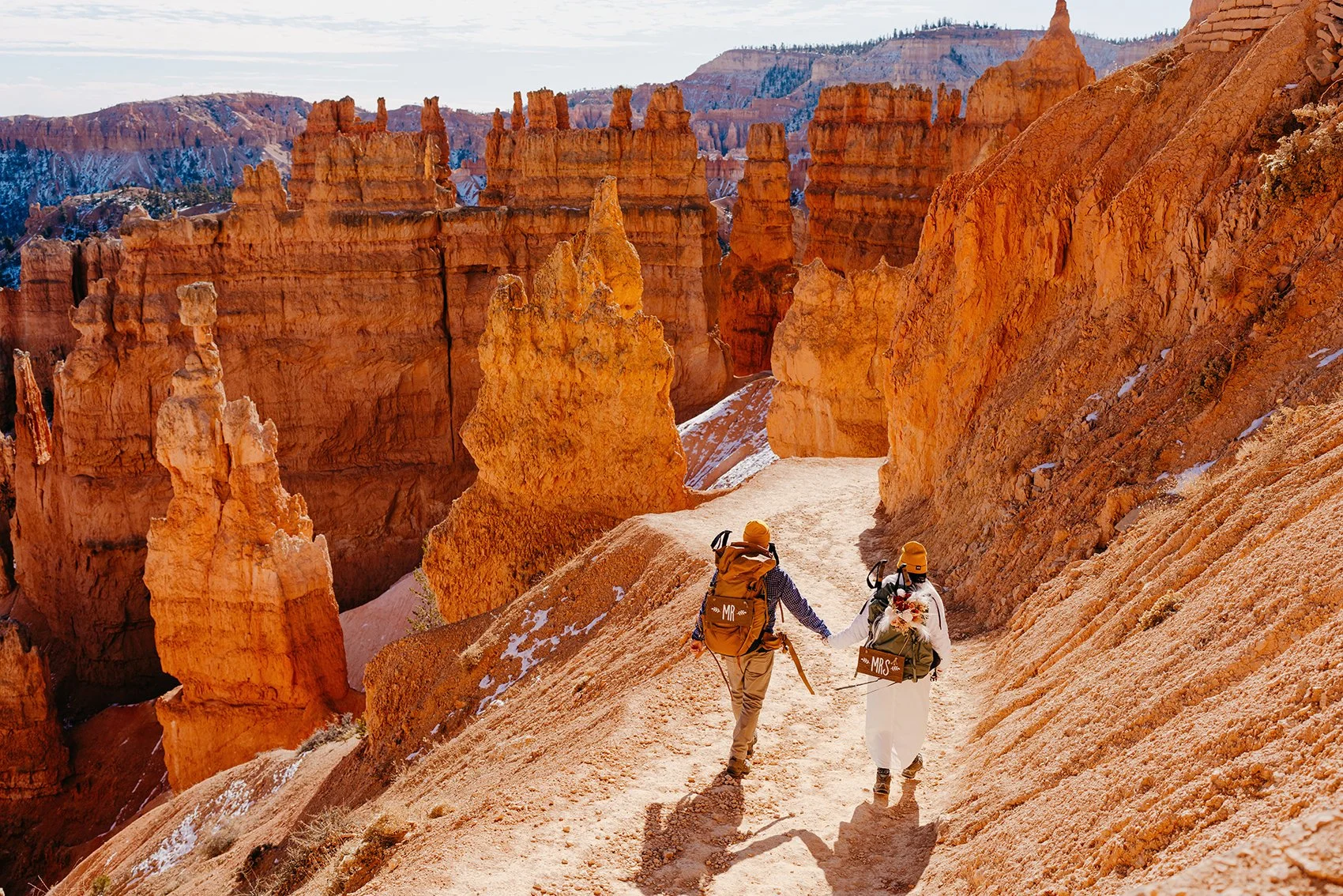 couple hiking to ceremony location in Bryce Canyon National Park