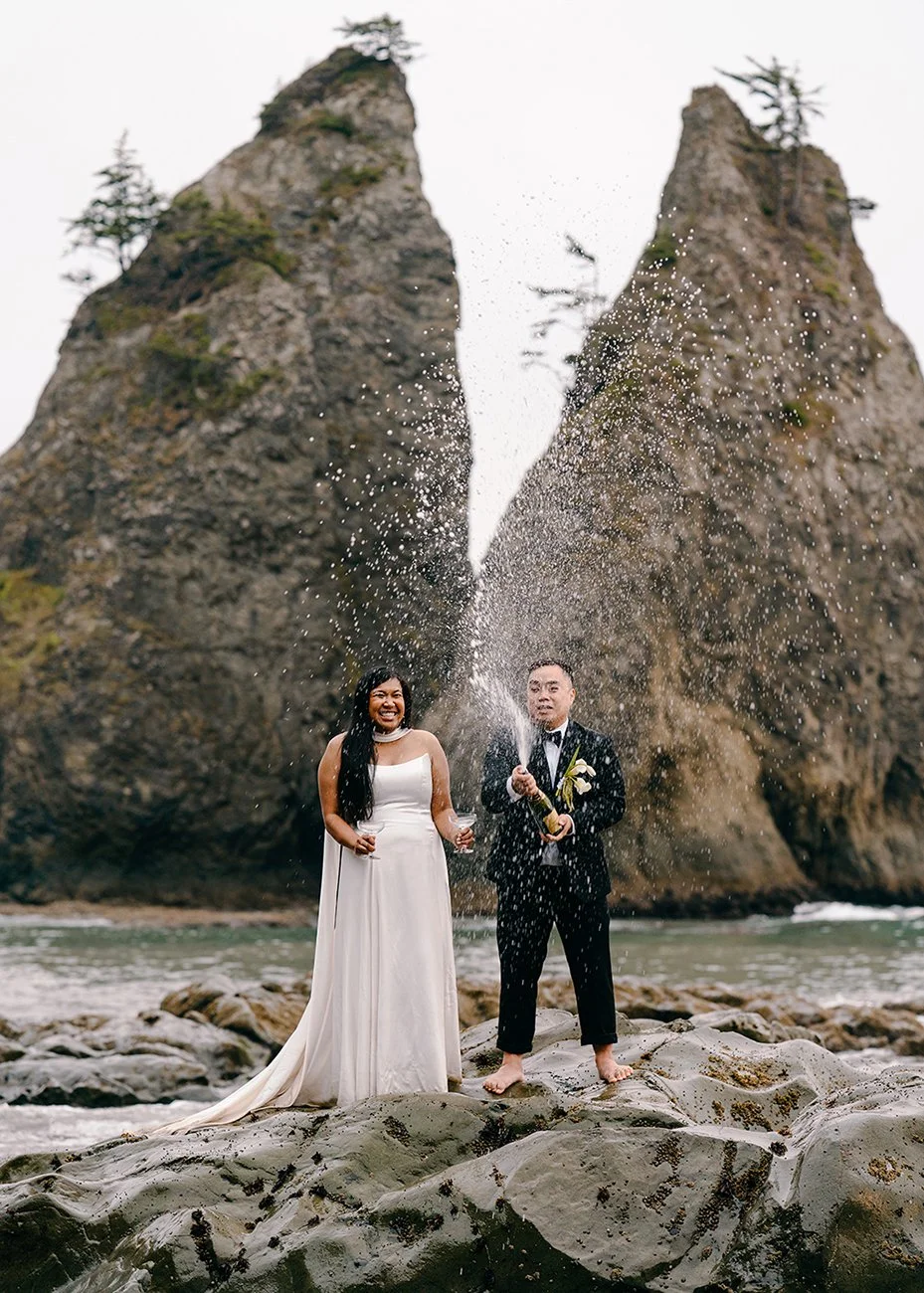 couple spraying champagne on Rialto beach elopement