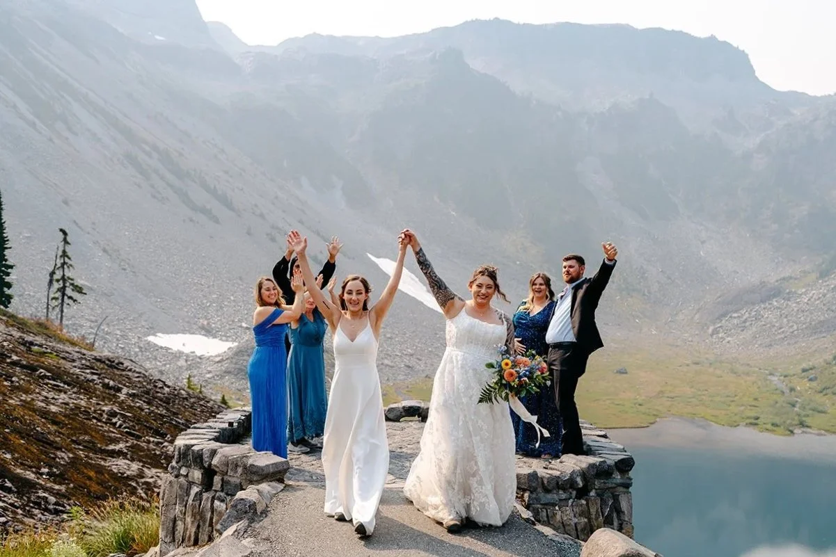 lesbian couple cheering at heather meadows ceremony in washington