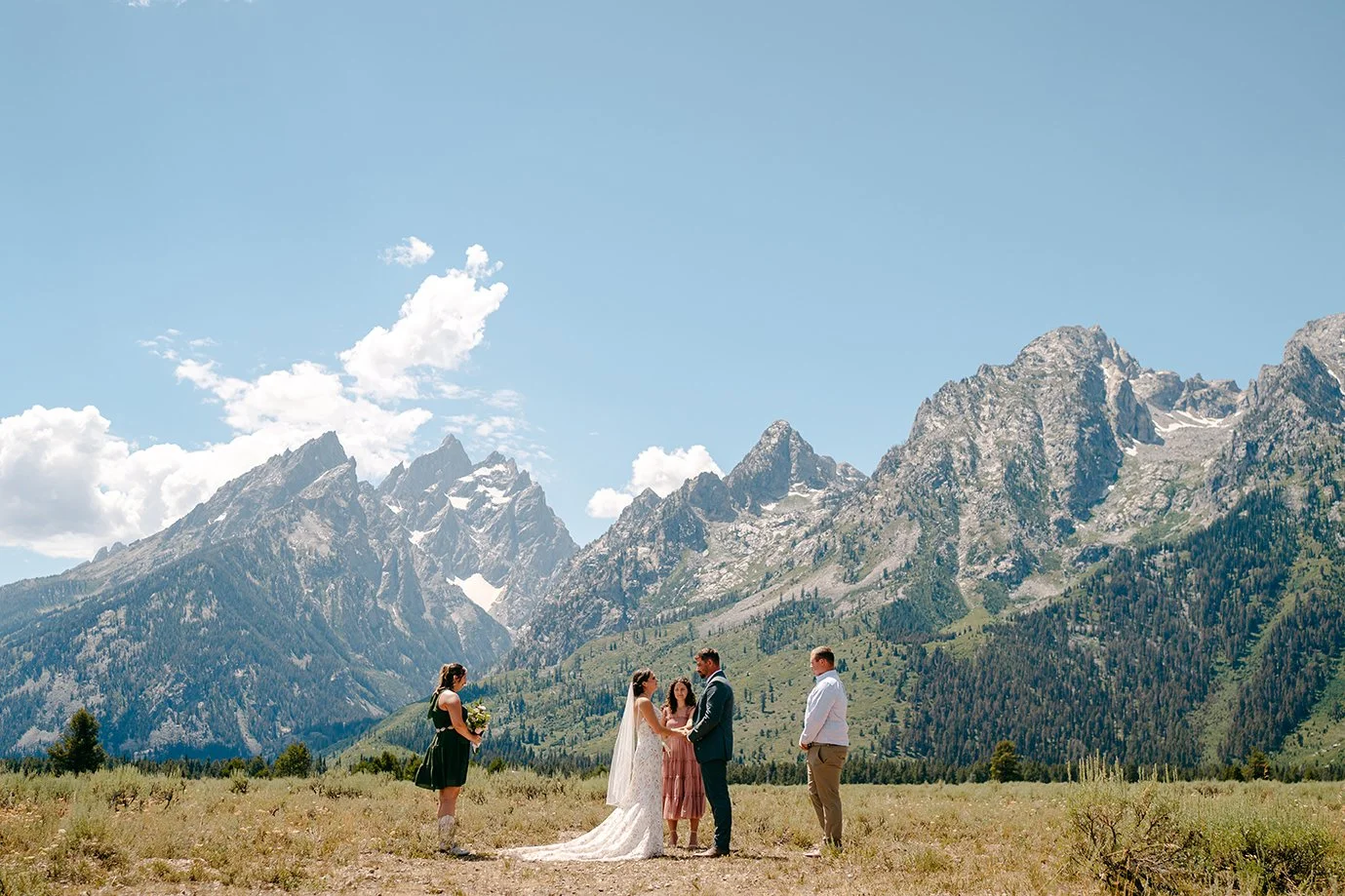 couple getting married in front of the grand Tetons