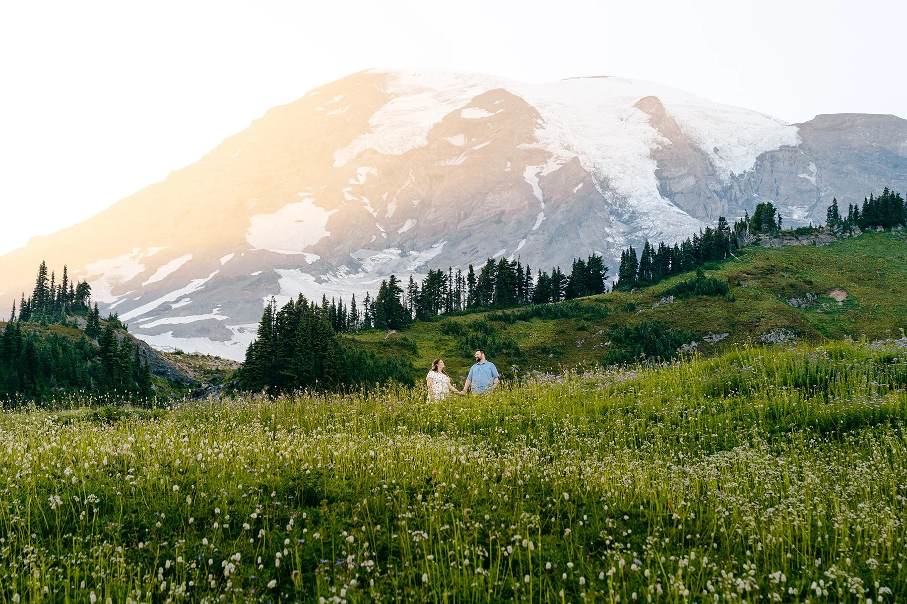 couple standing among wildflowers at mount rainier paradise