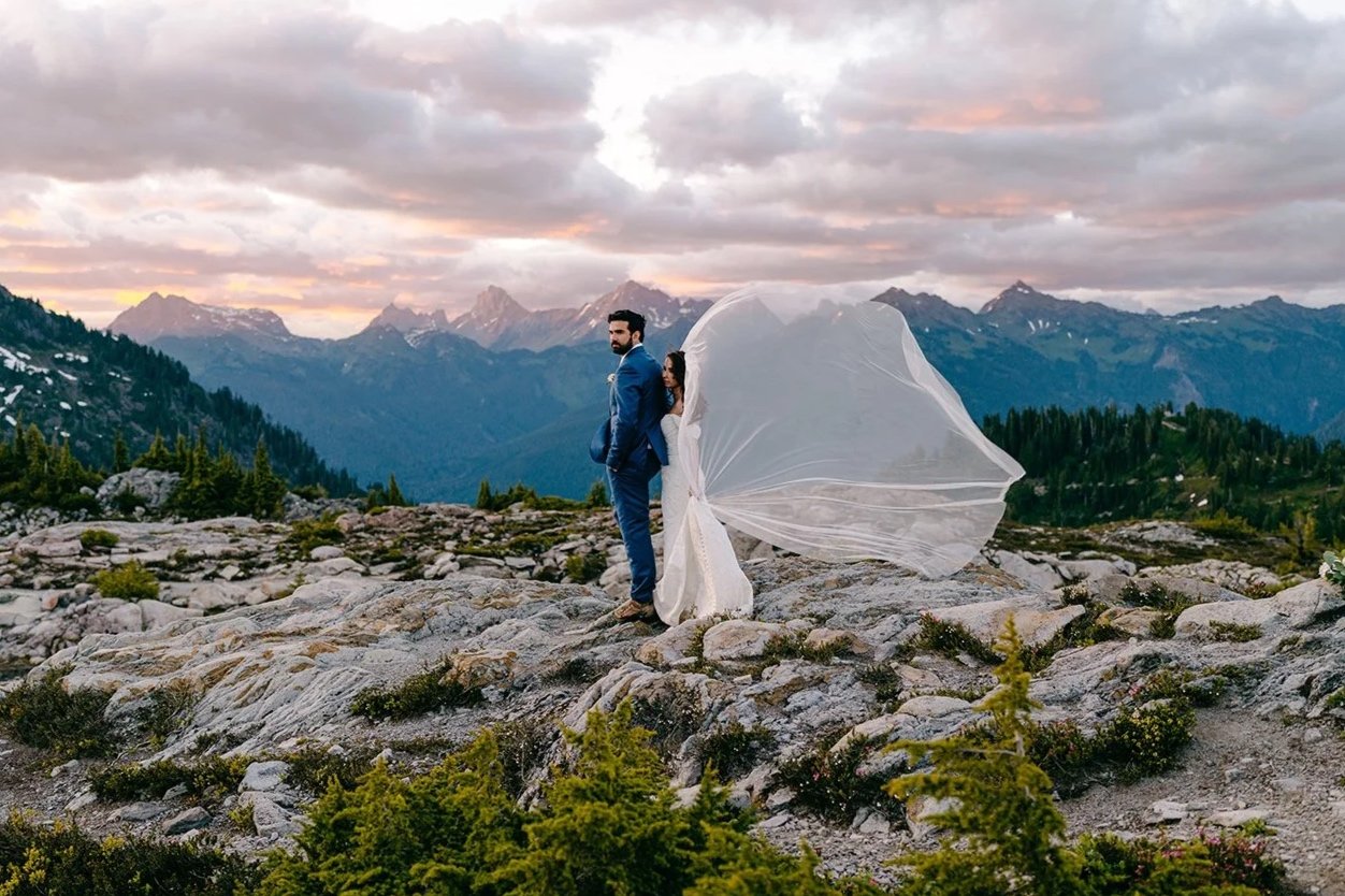 couple standing at huntoon point during sunset and her veil blowing in the wind