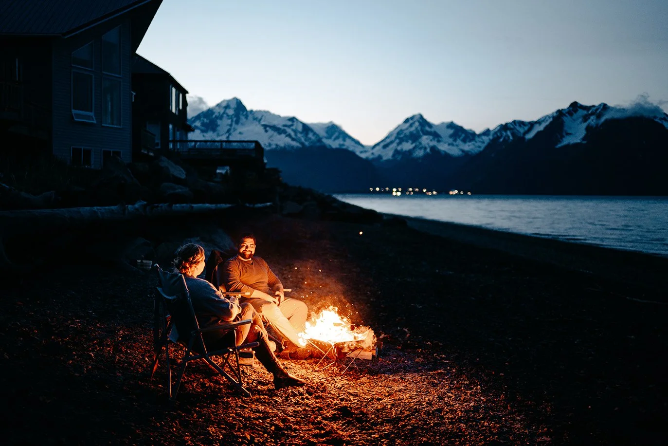 couple having a campfire in Seward Alaska after their mountain elopement