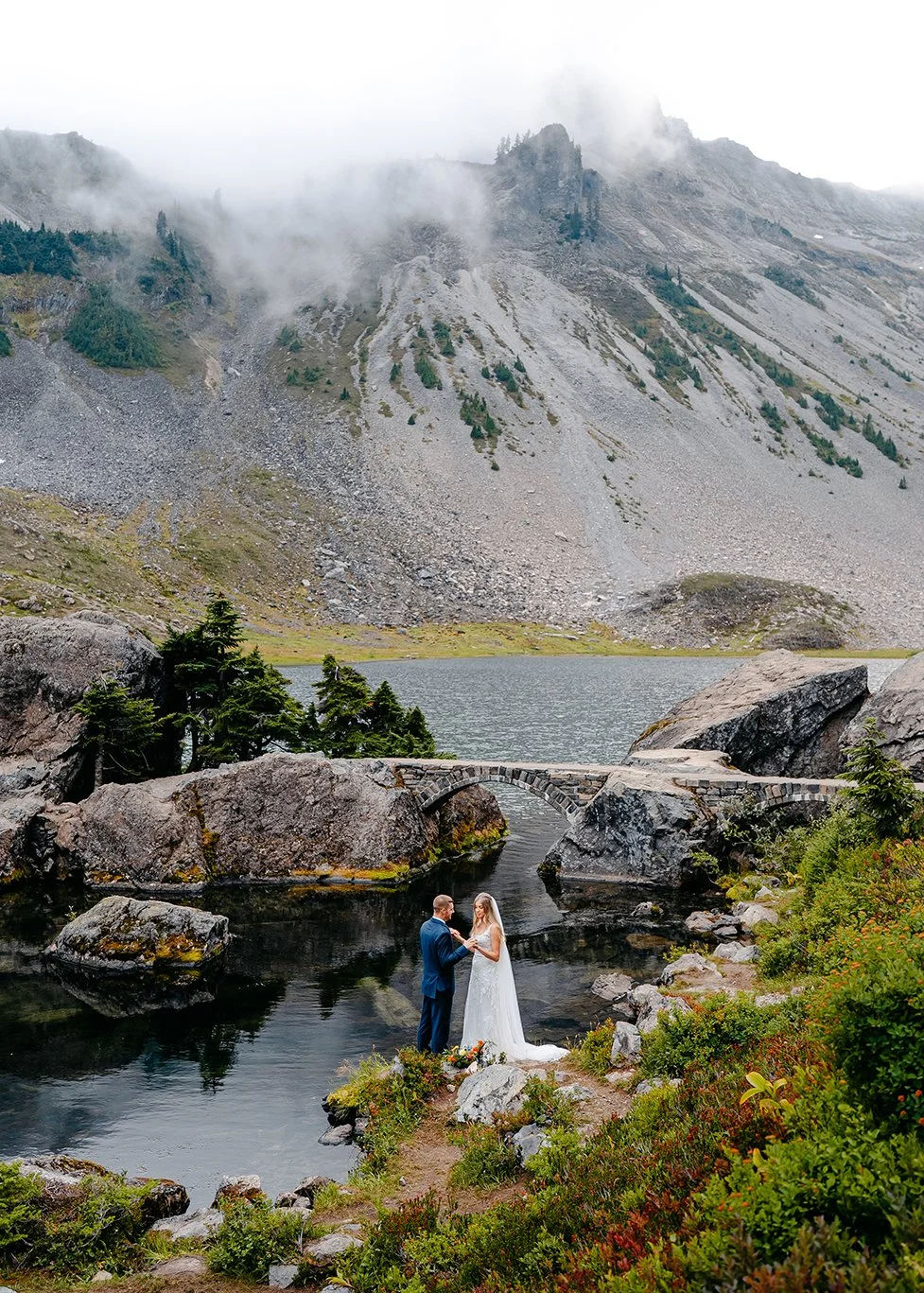 couple exchanging vows near bridge of heather meadows artist point washington