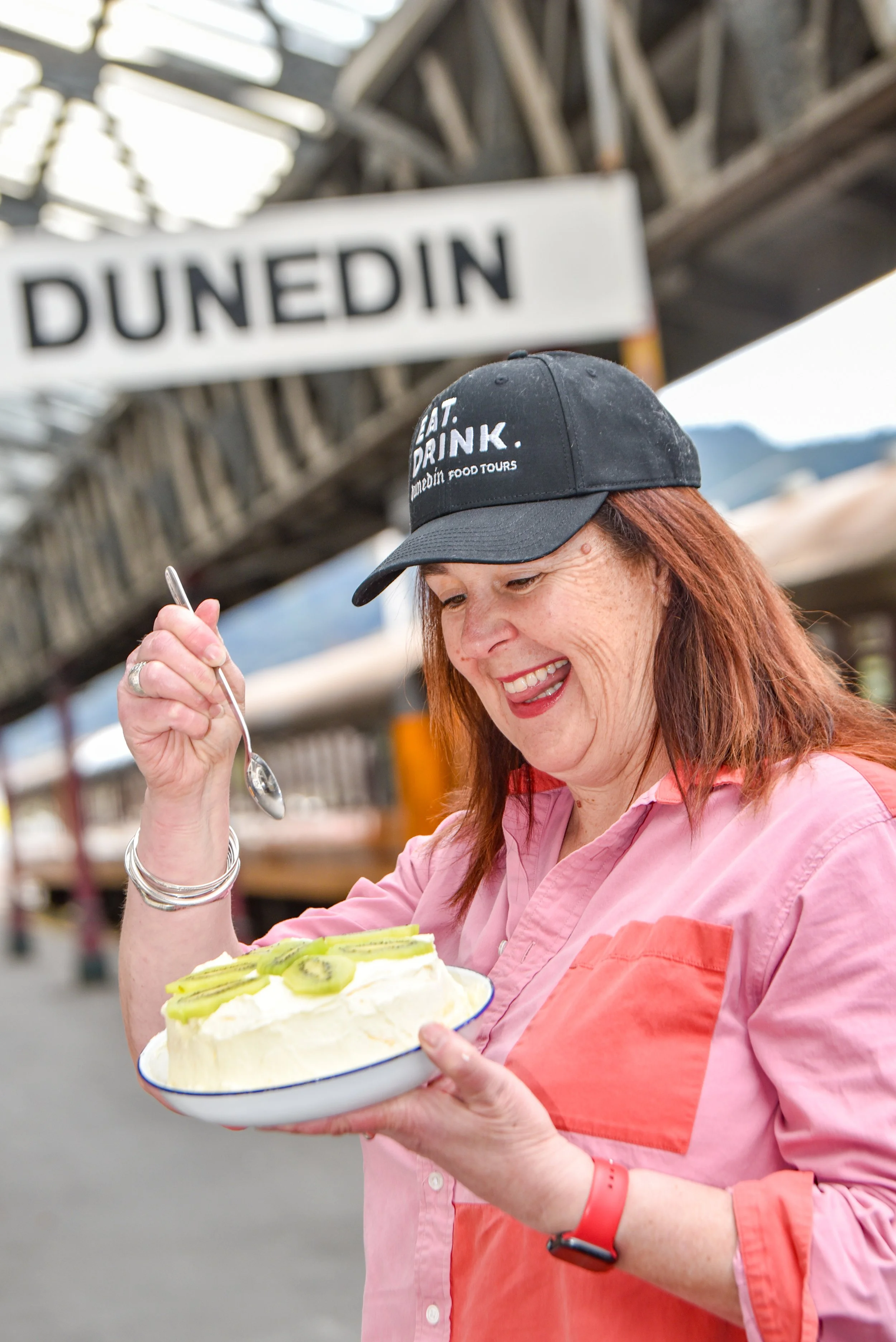 Nicola McConnell Eat Drink Dunedin Tour Guide with a New Zealand Pavlova at Dunedin Railway Station