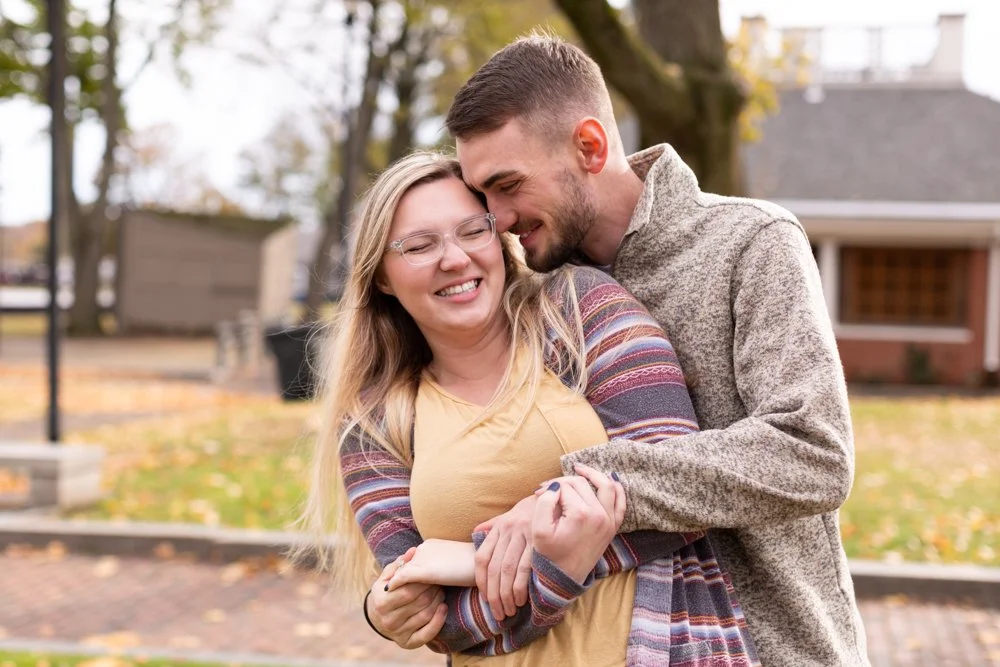 Engaged couple playing around in Prescott park