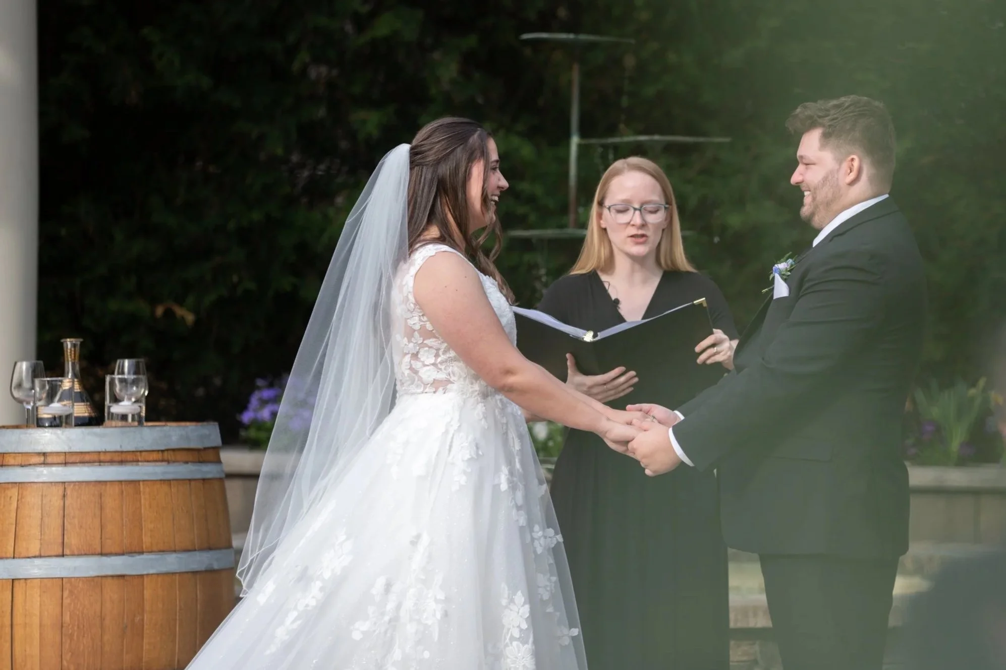 Bride and Groom smiling at each other during ceremony at Birchwood Vineyards in Derry, NH.