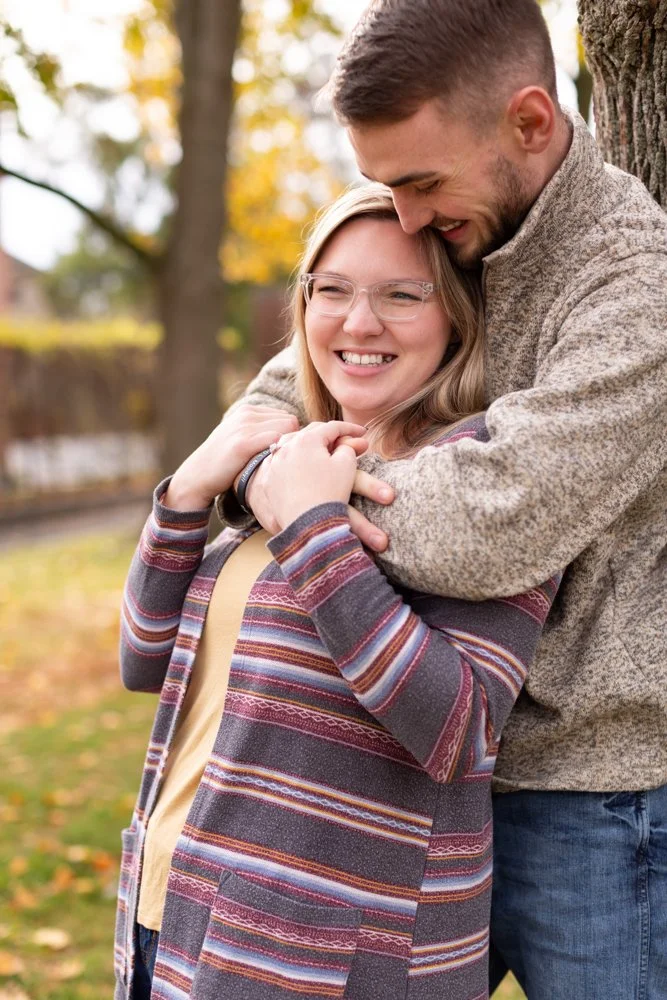 Engaged couple holding each other at Prescott Park
