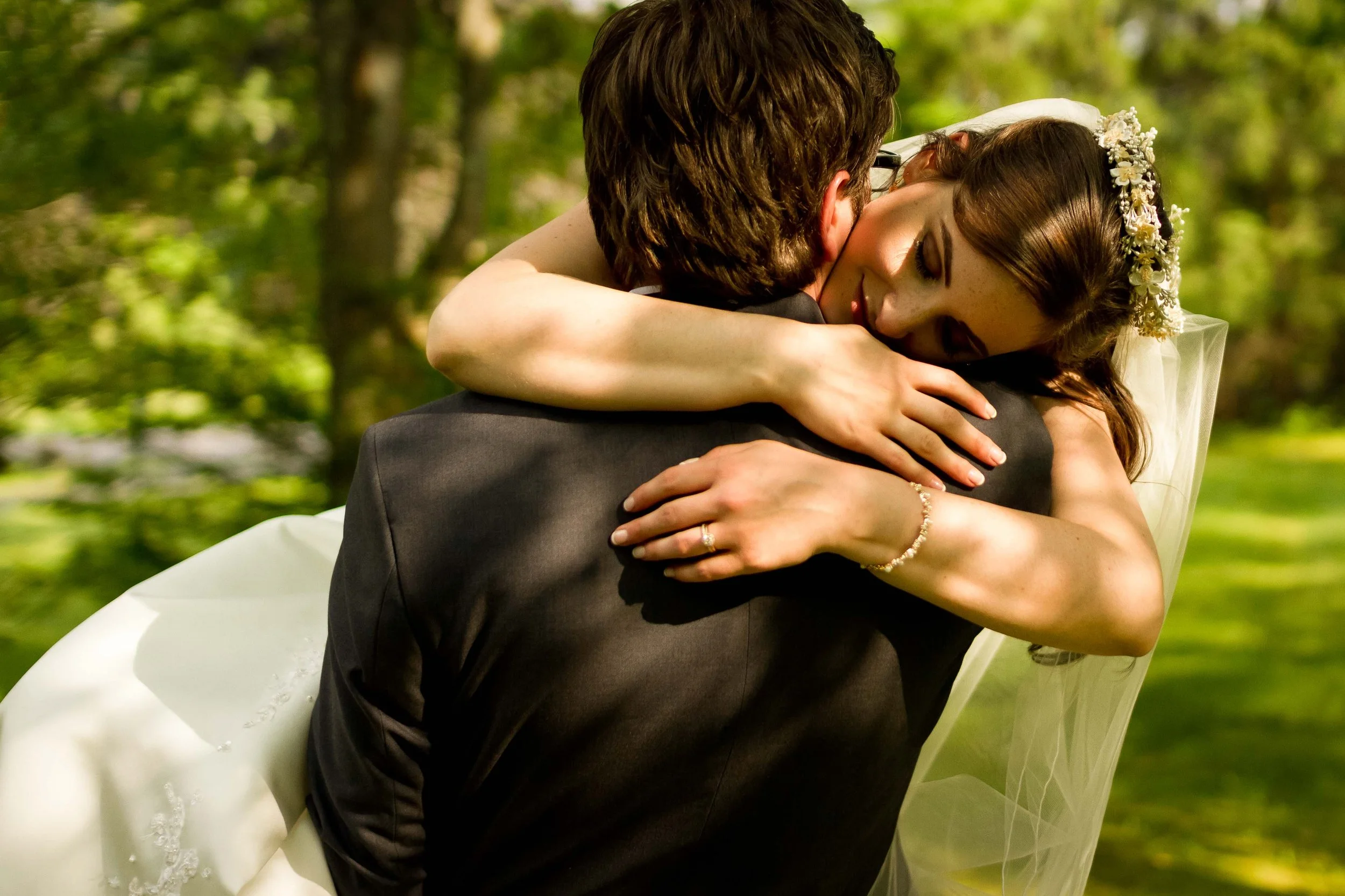Groom holding bride in his arms