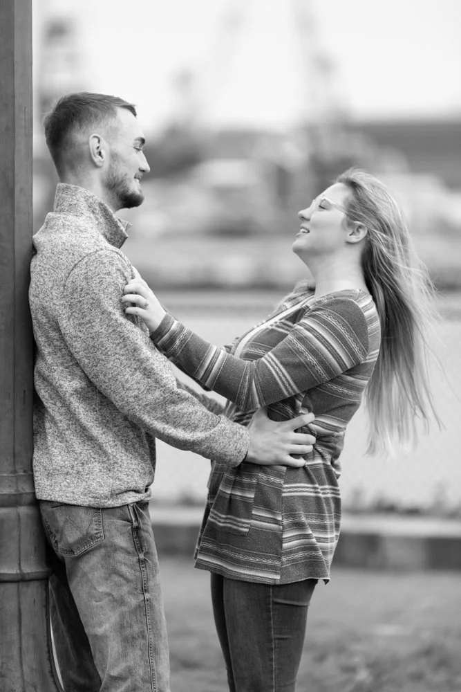 Engaged couple holding each other at Prescott Park