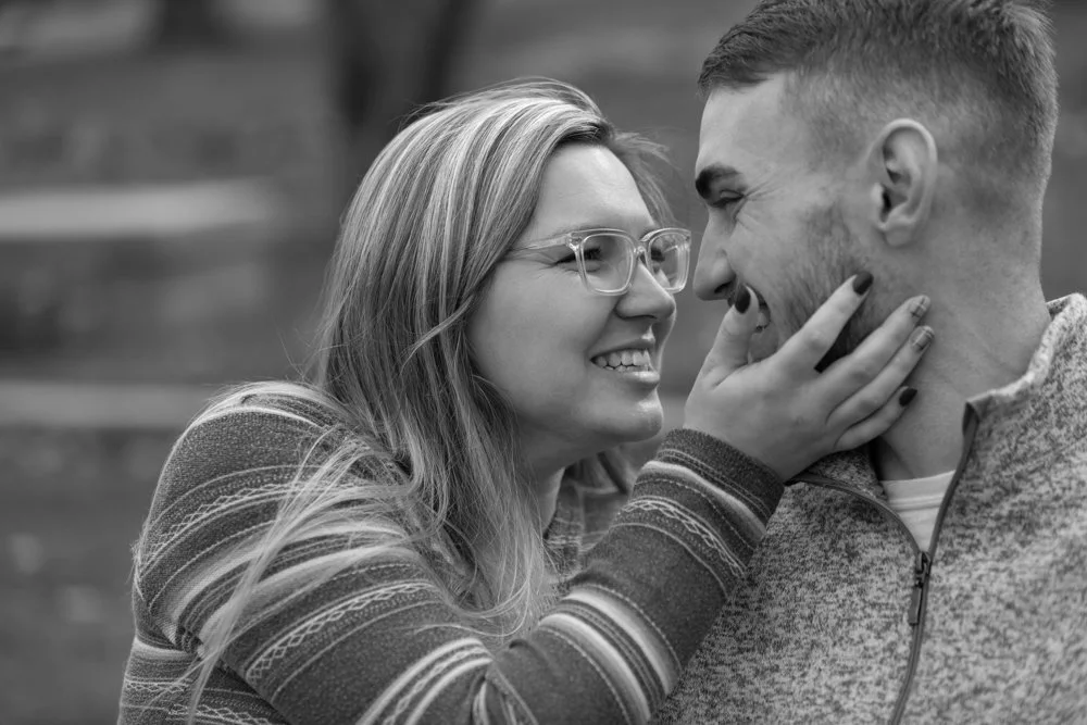 Engaged couple laughing with each other