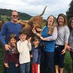 Seeing and feeding Highland Cows in the Highlands of Scotland during a day, group tour of Loch Lomond and the Trossachs National Park from Glasgow with Experience Scotland's Wild Tour Operator