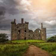 walk to Kilchurn Castle in the Highlands of Scotland during an adventure group tour, visiting Standing Stones, Inveraray Castle &amp; Kilchurn Castle starting in Glasgow with a Scottish Tour Operator