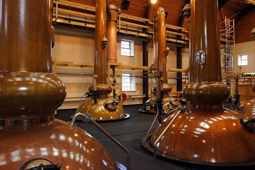 Copper stills inside a Scotch whisky distillery