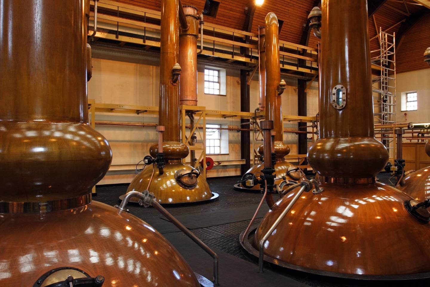 Traditional copper whisky stills inside a Scottish distillery
