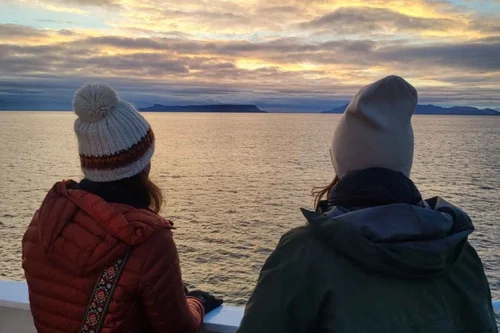 Two guests watching the sunset from the ferry