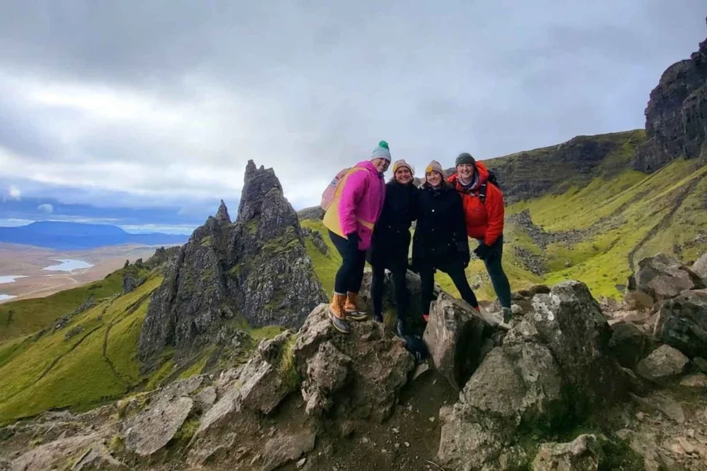 A small tour group on the rocks below the Old Man of Storr on the Isle of Skye