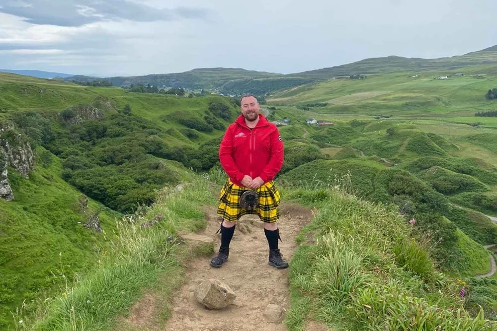 A Scotland's Wild guide in a kilt telling stories in the Fairy Glen on Skye