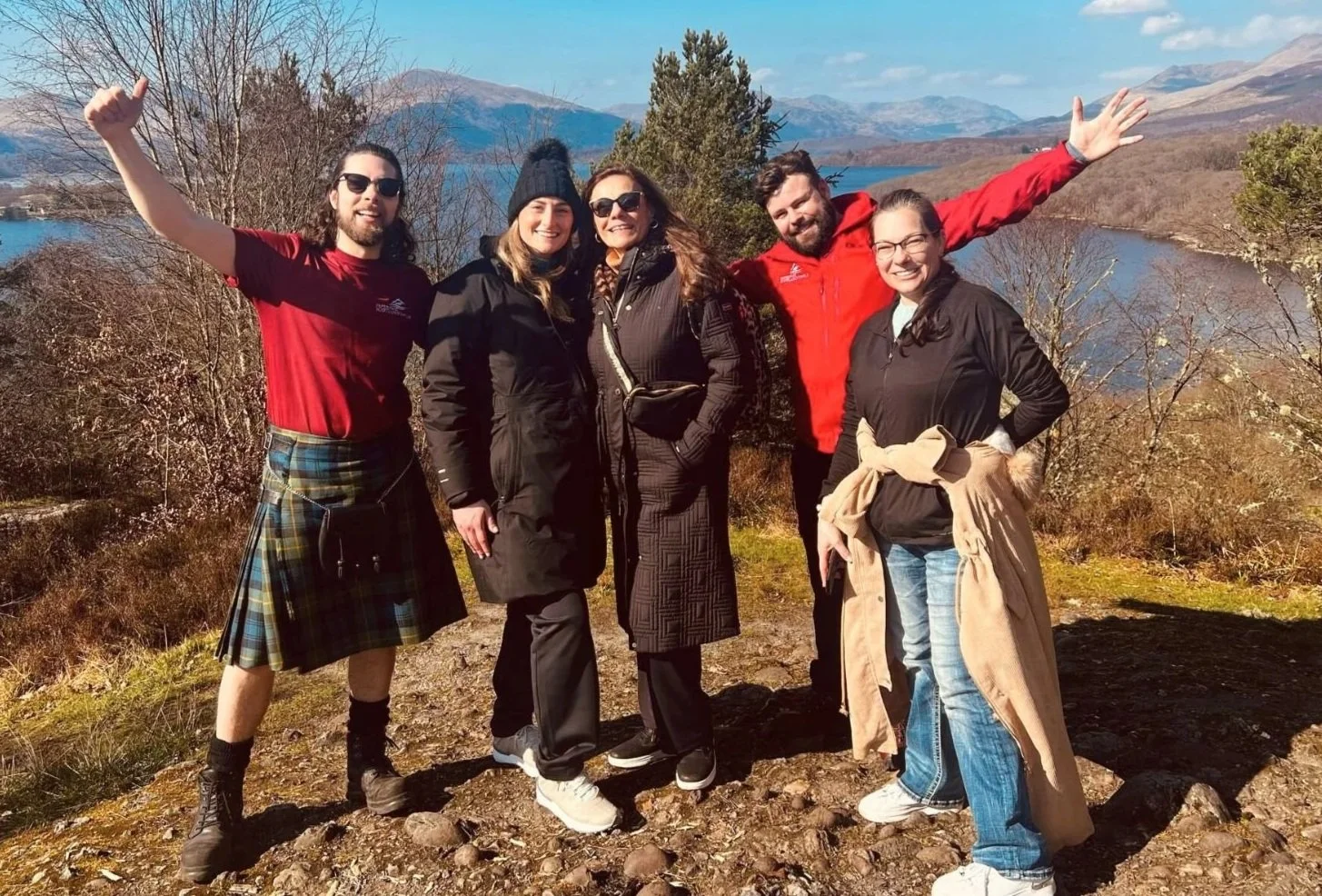 Happy Scotland's Wild travellers beside a Highland loch