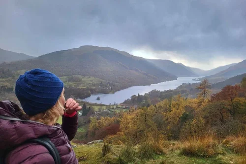 A traveller looking out over a Highland loch and mountains