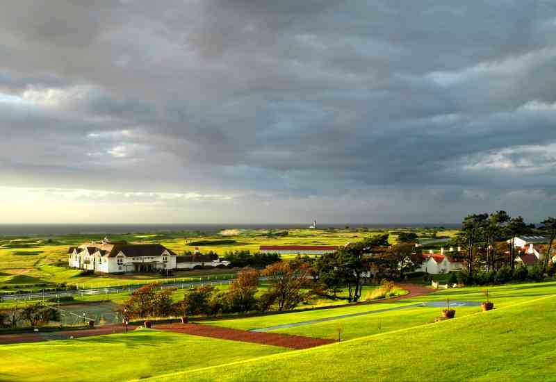 Scottish golf course beneath dramatic skies