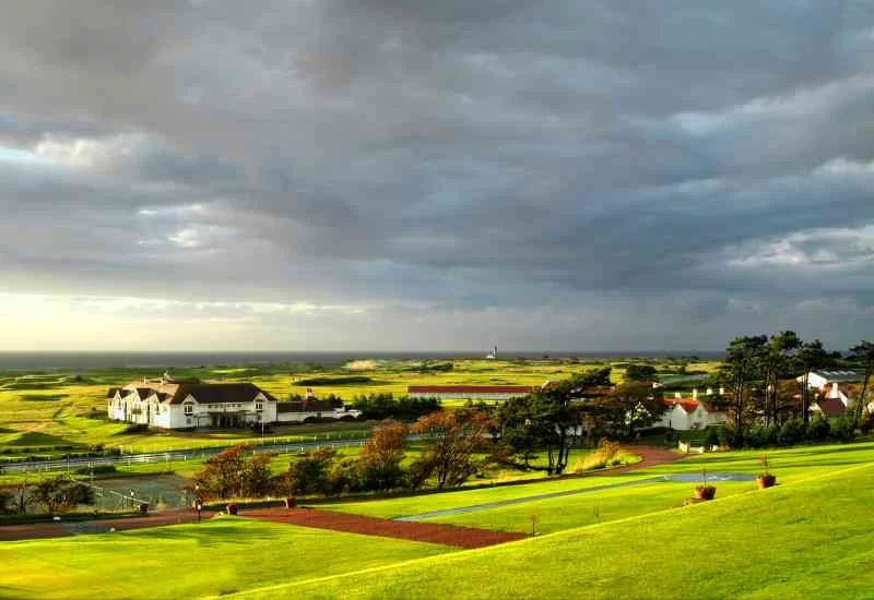 Scottish golf course beneath dramatic skies