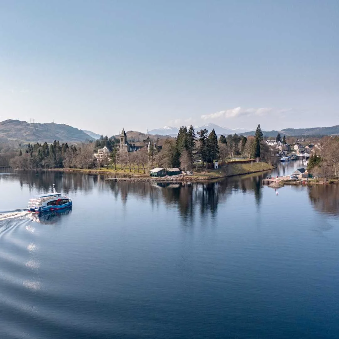 Boat travelling beside Fort Augustus at Loch Ness