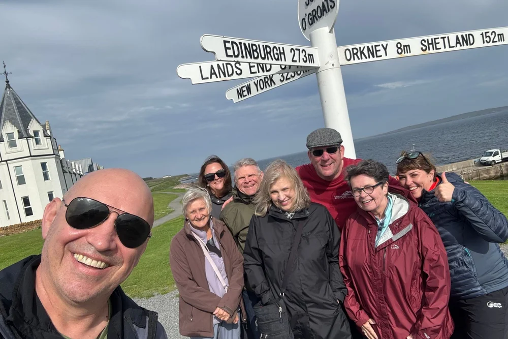 Scotland's Wild guide Richie with tour guests at John O' Groats