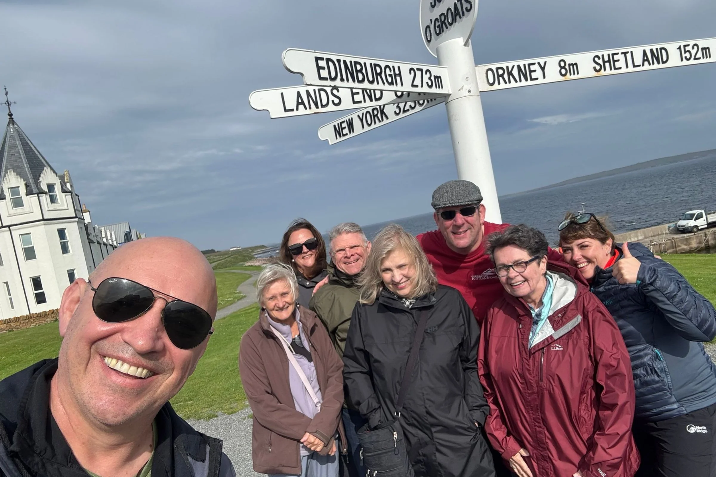 Scotland’s Wild guide and guests at the John o’ Groats sign