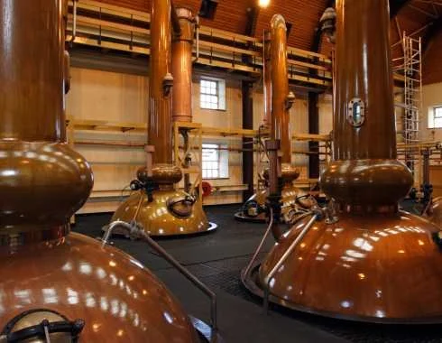 Copper stills inside a whisky distillery