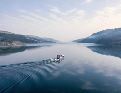 Cruise boat travelling across Loch Ness