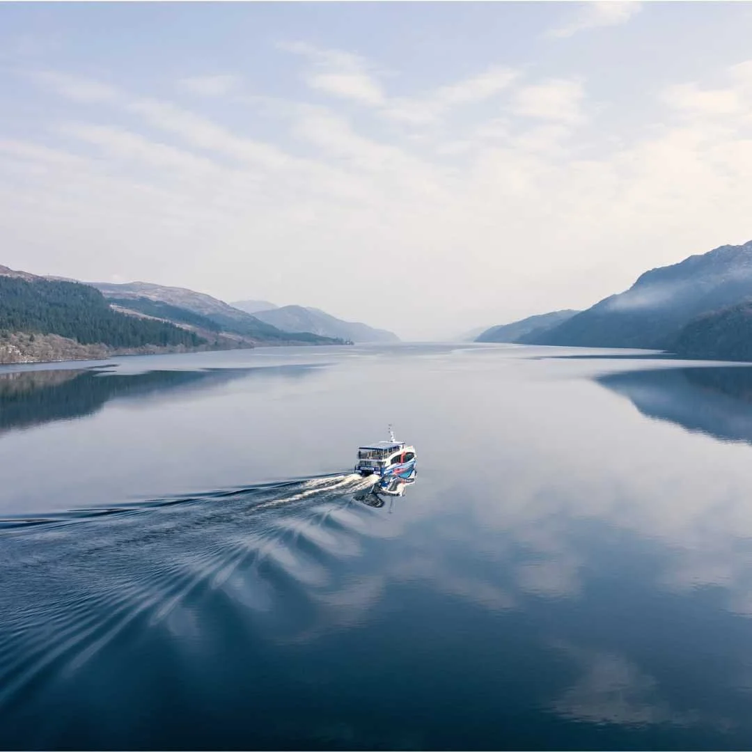 Boat travelling across Loch Ness in the Scottish Highlands
