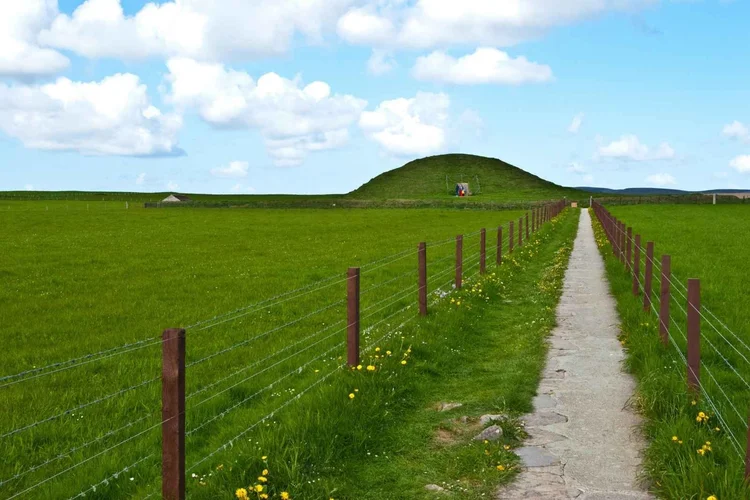 The grassy mound of Maeshowe chambered cairn on Orkney