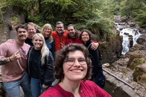 A small tour group at the Black Linn waterfall at The Hermitage near Dunkeld