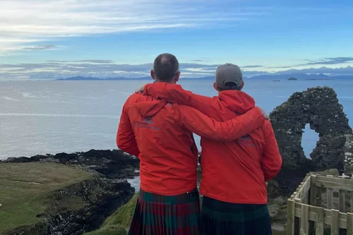Two Scotland's Wild guides looking out over the ruins of Duntulm Castle on Skye
