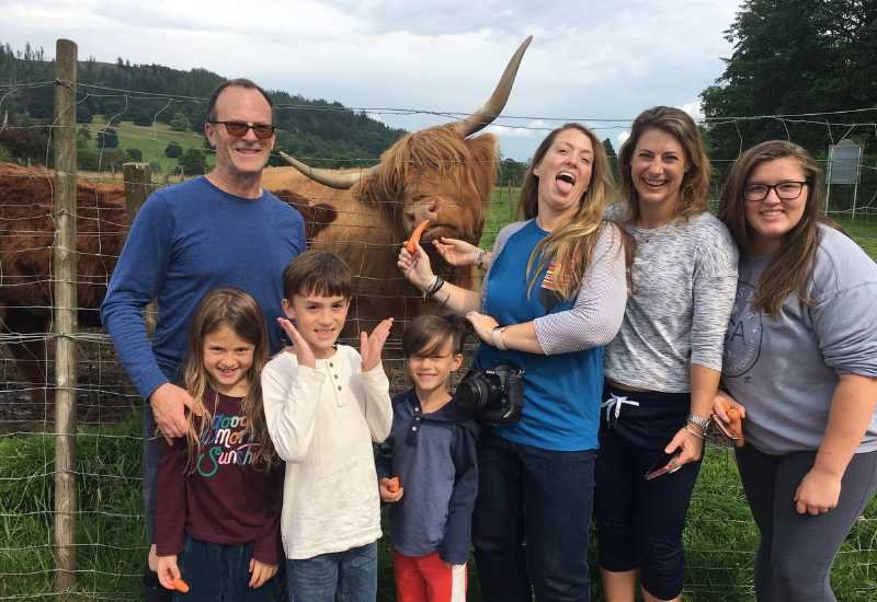 A family meeting Highland cows on a private Scotland tour