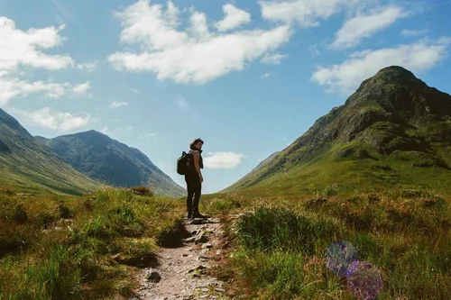 A traveller on a walking path through Glencoe