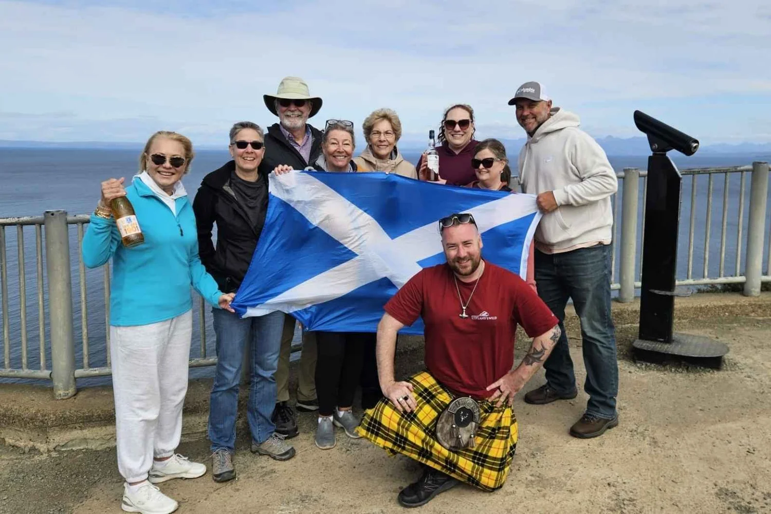 Guide Matt and guests with a Saltire on the coast
